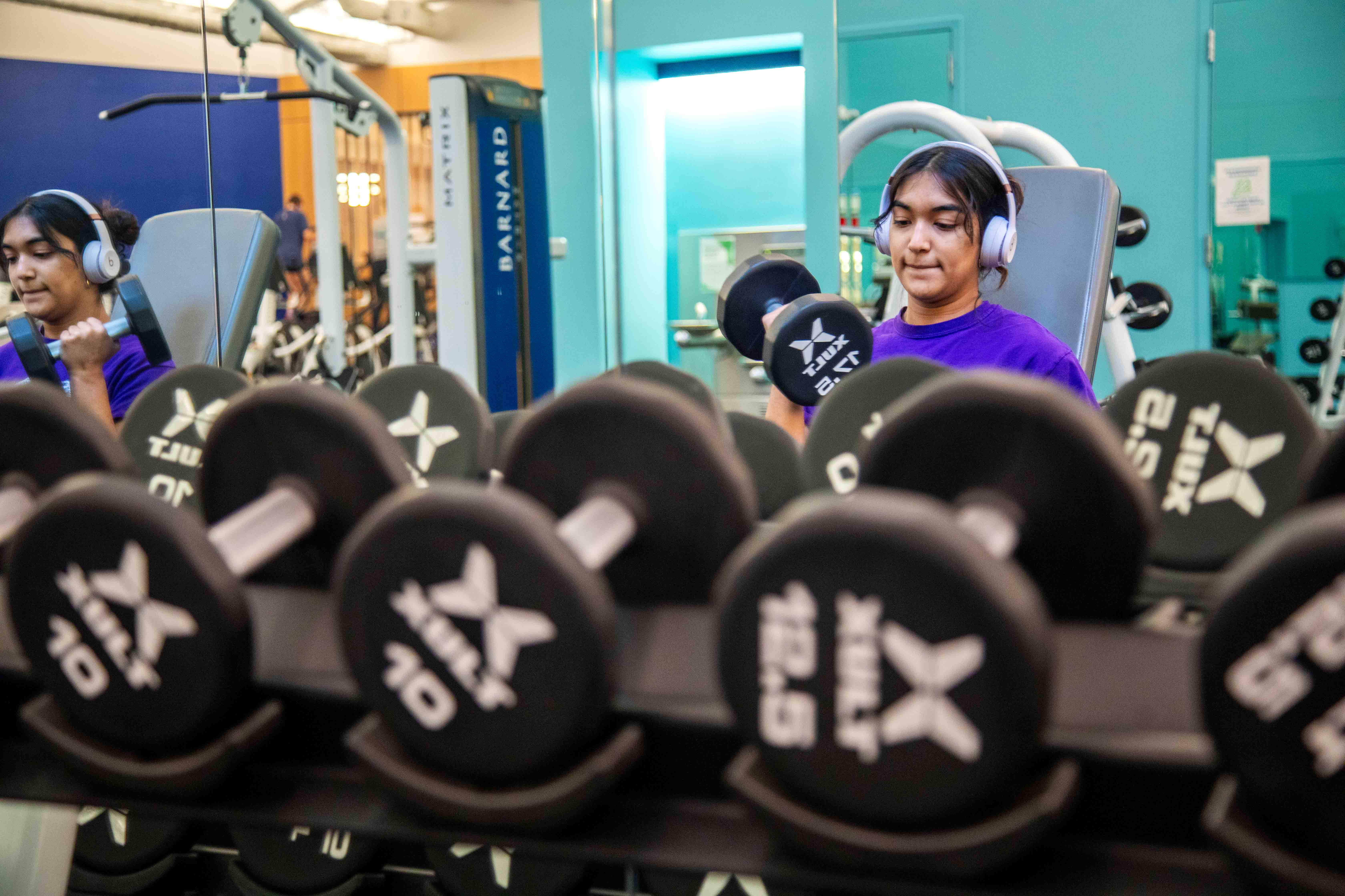 woman Weight lifting with headphones